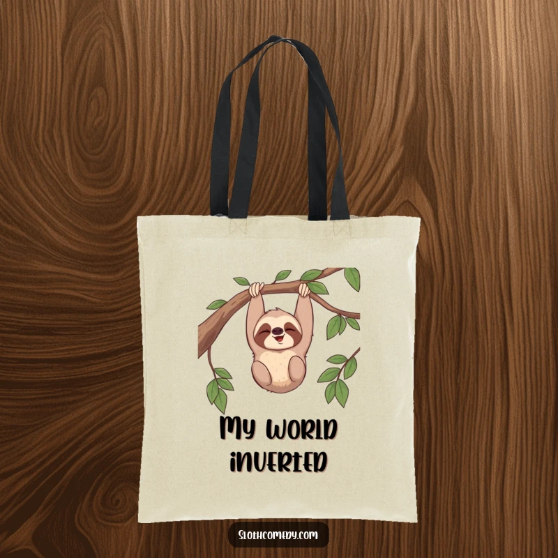 Funny tote bag with a sloth giggling while hanging upside down from a branch, perfect for carrying items with cheerful humor.