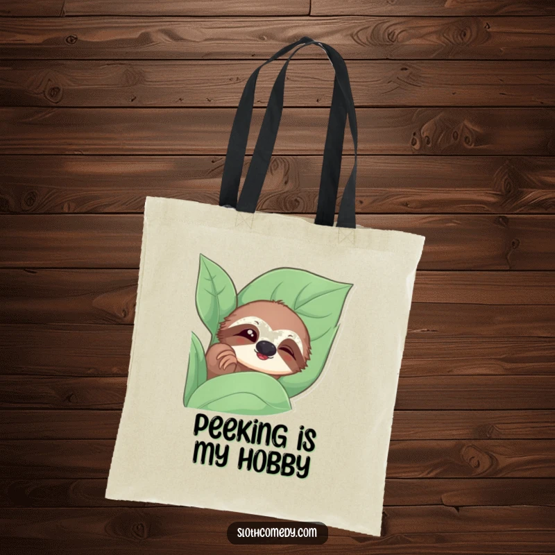 Funny tote bag with a sloth peeking from behind a leaf, giving a slow blink, for everyday charm.